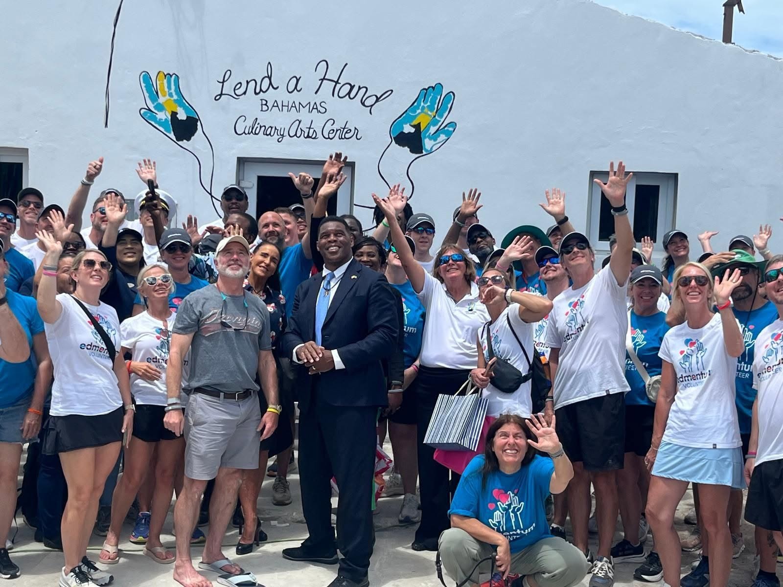 A group waving outside the Lend a Hand Bahamas Culinary Arts Center